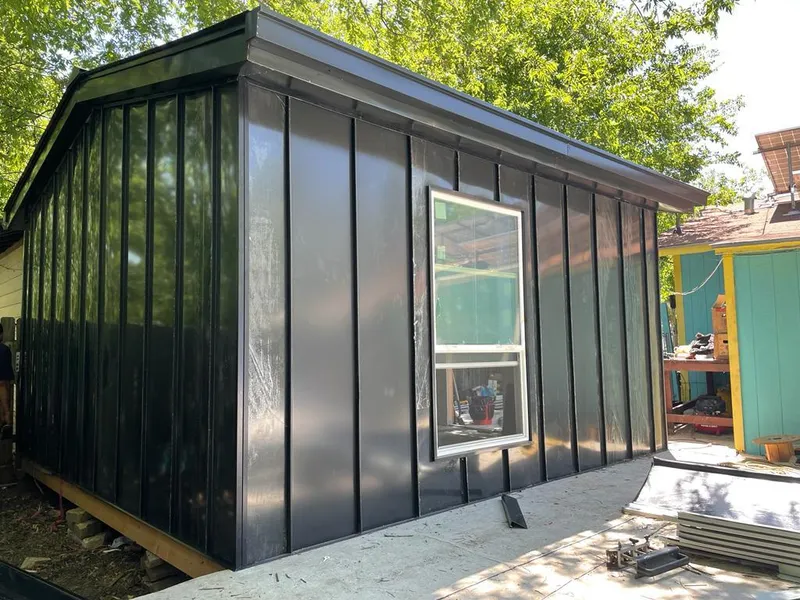 Black standing seam metal wall panels for Roof Inspection in Granville