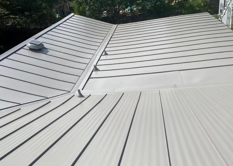Solar attic fan installed on a metal roof for Roof Ventilation in Granville